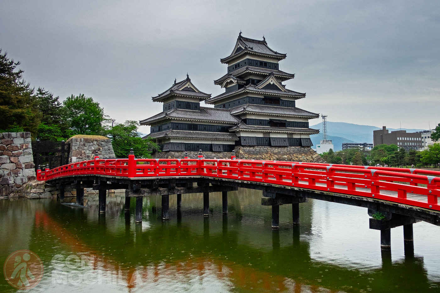 Matsumoto Castle and the bright red bridge over the pond