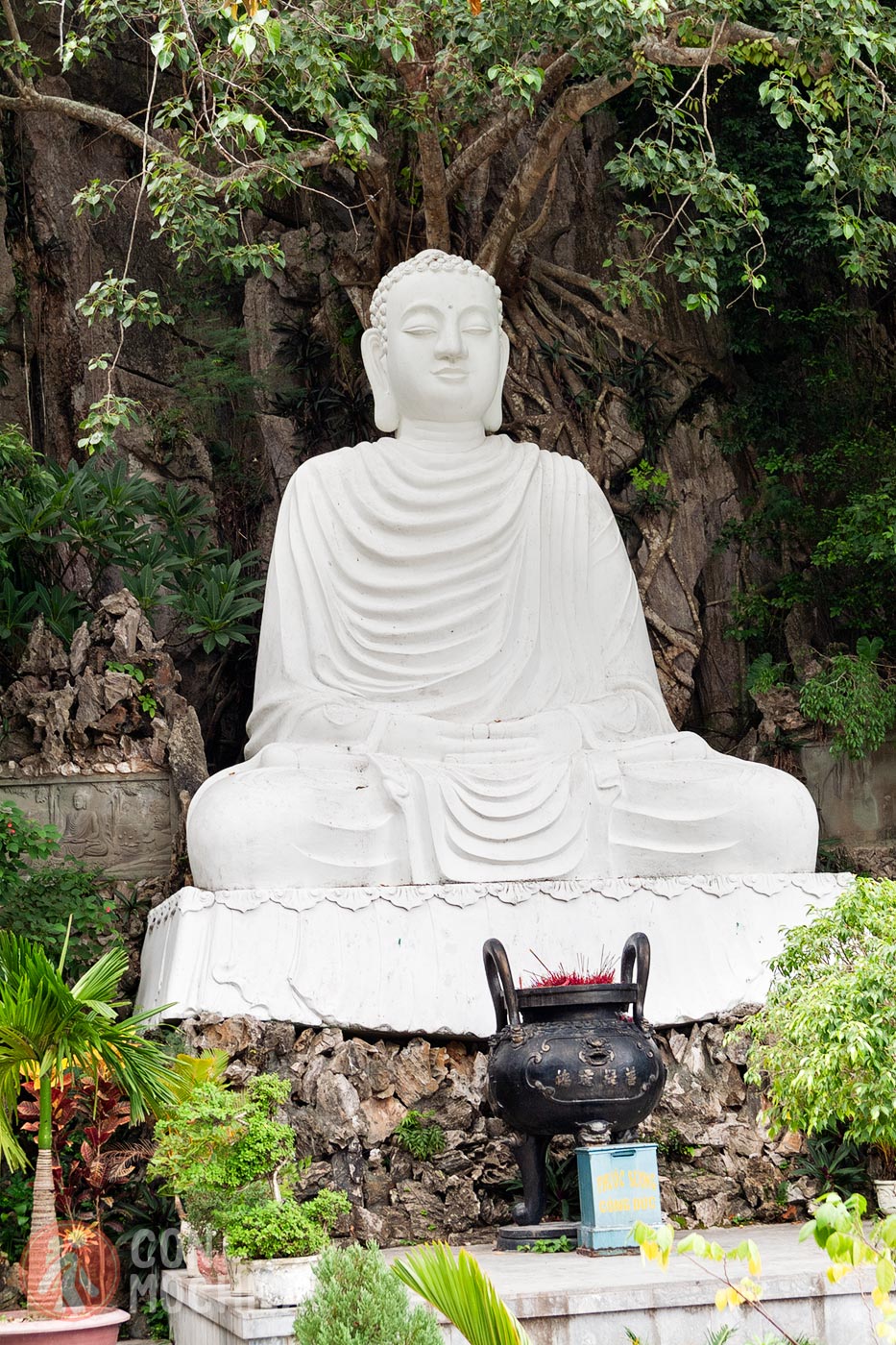 Cement Buddha at the entrance of Van Thong Cave