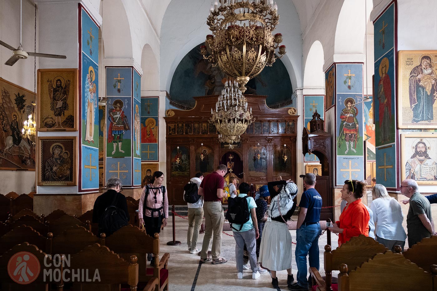 Tourists surrounding the mosaic inside