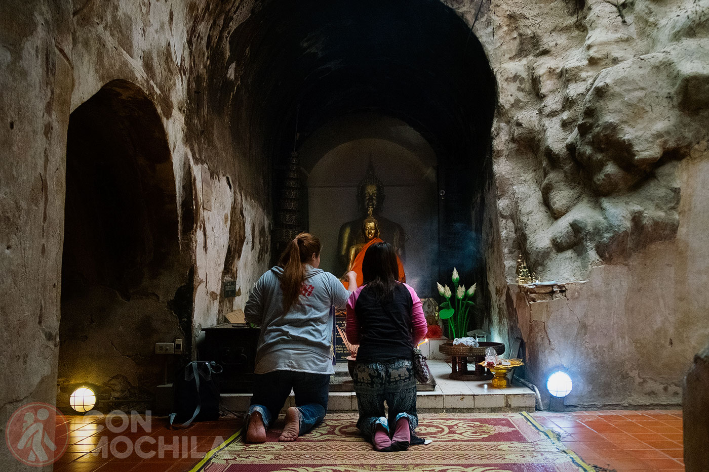 Devotees praying in front of a Buddha image