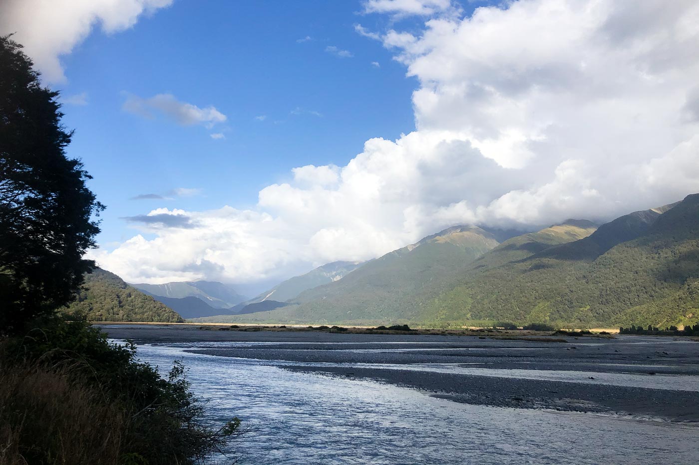 A scenic road through mountains, rainforests, and waterfalls