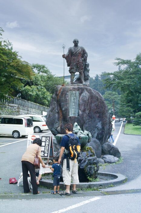 La estatua de un yamabushi, monjes ascetas que peregrinan por las montañas, preside un parking en Nikko